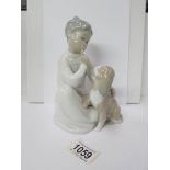 A Lladro figure of a boy with his dog