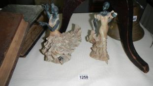 A pair of pottery figures of Spanish dancers