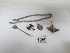 A silver ray brooch, a silver axe pendant, a silver fob,