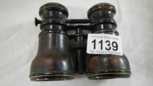 A pair of opera glasses marked Marine Field Theatre