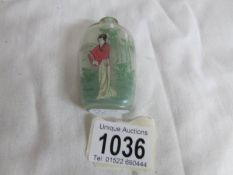 A scent bottle with oriental ladies depiction,