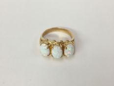 A large 3 stone yellow gold and opal ring,