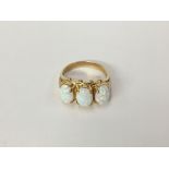 A large 3 stone yellow gold and opal ring,