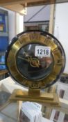 An Art Deco amber glass clock with BEM electric movement