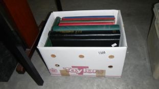 A box of 10 new and used spring back stamp albums