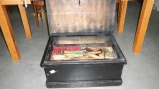 A black wooden tool box containing large quantity of wood working tools,
