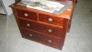 A small mahogany 2 over 2 chest of drawers