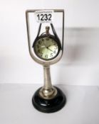 A heavy glass ball pocket watch in stand