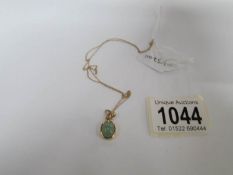 A 9ct gold and jade pendant