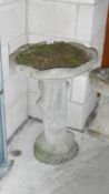 A concrete garden bird bath