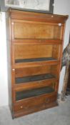 A 6 piece globe Wernicke style bookcase consisting of 2 drawer base,