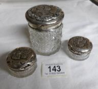 3 19th century silver topped dressing table jars embossed with angels and cherubs on lids