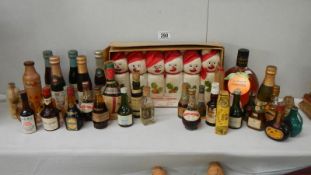 A collection of vintage miniature drinks including snowmen decorated, whisky, cognac,