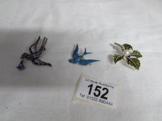 An enamel blue bird brooch and 2 others