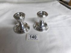 A pair of small Birmingham silver candlesticks