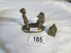 An old brass figure of bear tamer with bear together with an old brass Buddha