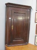 An oak corner cupboard