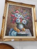 A gilt framed oil painting of floral arrangement