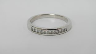 An 18ct white gold eternity ring with channel set diamonds