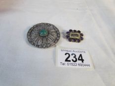 A Georgian amethyst brooch with seed pearls to surround of hair locket and one other silver brooch