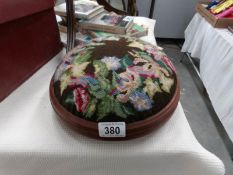 An embroidered foot stool