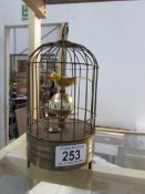 A novelty bird in cage clock