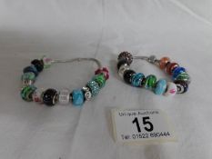 2 Pandora bracelets with assorted charms including Pandora,