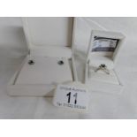 A matching silver ring and earrings set with synthetic emerald