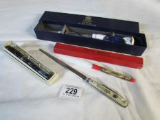 A Royal Worcester paper knife, a Tower of London paper knife,