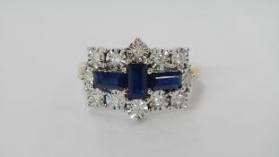 A sapphire and diamond cross shaped gold ring