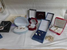 A mixed lot of costume jewellery including earring and necklace sets, brooches,