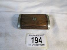 An old teak snuff box inlaid with metal