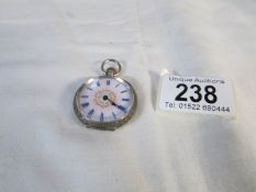 A silver fob watch,