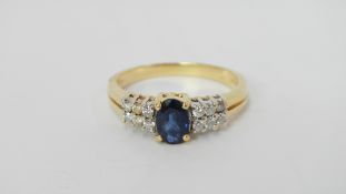 A modern 18ct yellow gold diamond and sapphire ring