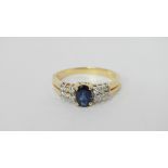 A modern 18ct yellow gold diamond and sapphire ring