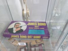 2 Corgi James Bond gold Aston Martin cars and a 1960's 007 board game