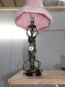 A figural table lamp with shade