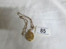 A 9ct gold chain attached oval locket