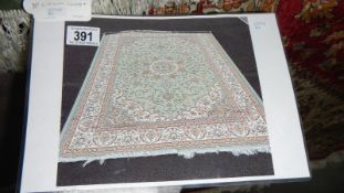 A green ground Keshan rug,