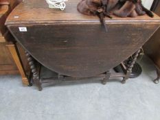 An oak barley twist gate leg table