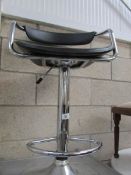 A chrome and black bar stool