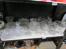 A shelf of assorted glass ware