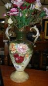A Staffordshire vase containing ceramic roses