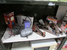 A shelf of tools including wood planes