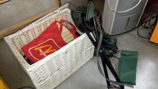 A wicker trunk containing shopping bags etc and 2 folding stools