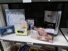 A shelf of kiitchen ware including coffee machine, cafetiere, 3 clocks etc