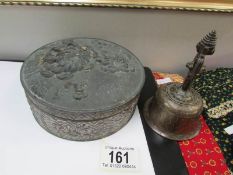 An embossed metal box and a metal bell