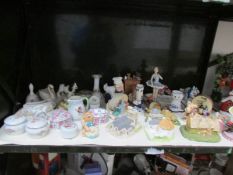 A shelf of miscellaneous china including trinket pots, cottages etc