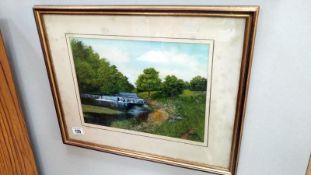 A framed and glazed river scene