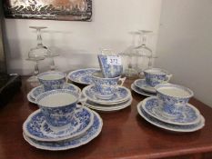 An 18 piece willow pattern tea set with cake plate and 6 Babycham glasses